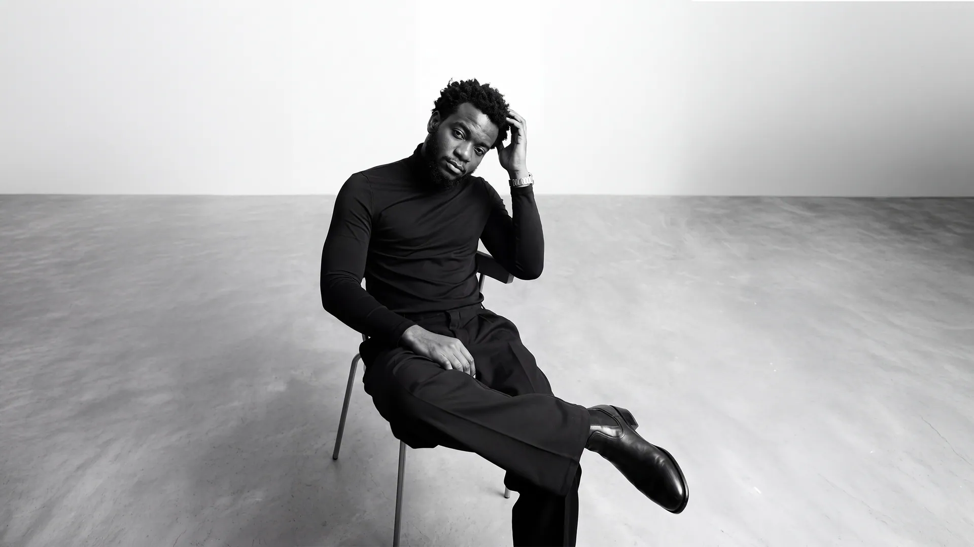 Oluwasegun Elijah Ajanaku seated in a white studio
